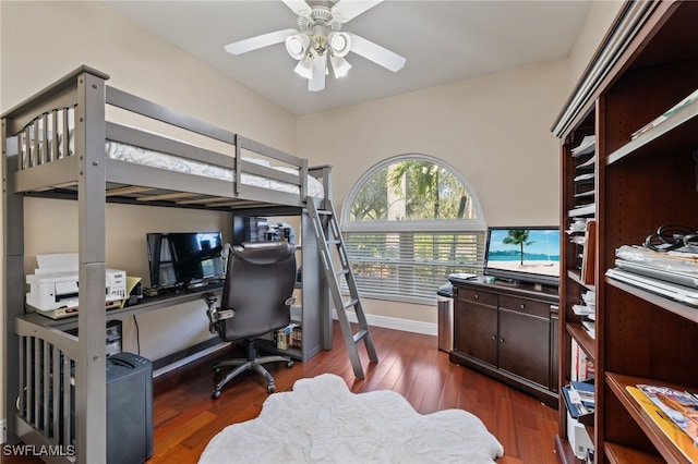 bedroom with baseboards and dark wood finished floors