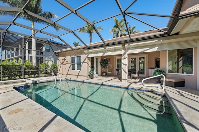 view of pool with a patio area, french doors, glass enclosure, and a pool with connected hot tub