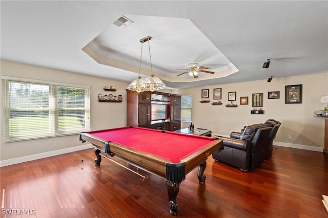 rec room with a tray ceiling, dark wood-style flooring, visible vents, and crown molding