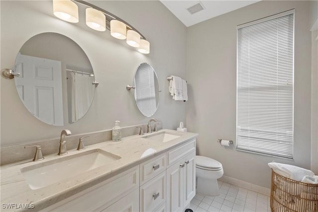 full bath featuring toilet, a sink, visible vents, and tile patterned floors