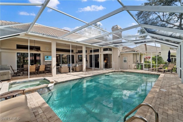 view of swimming pool with a pool with connected hot tub, glass enclosure, and a patio