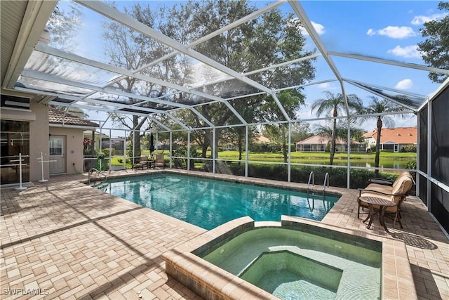 view of swimming pool featuring glass enclosure, a pool with connected hot tub, and a patio