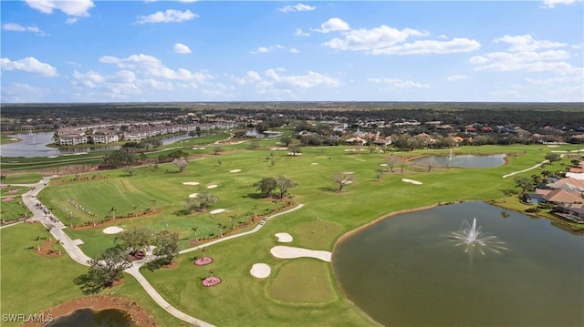 bird's eye view with view of golf course and a water view