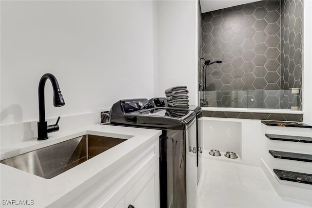 laundry area featuring sink and washing machine and dryer