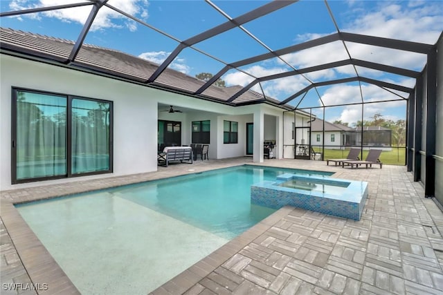 view of pool featuring an outdoor hangout area, an in ground hot tub, ceiling fan, a patio, and glass enclosure