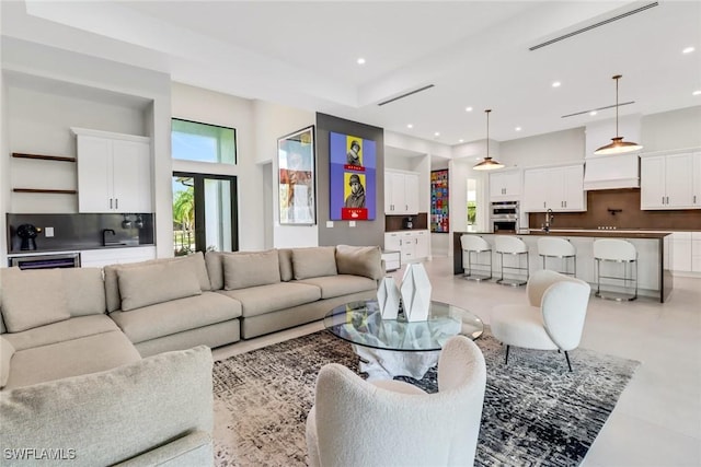 living room with sink and a high ceiling