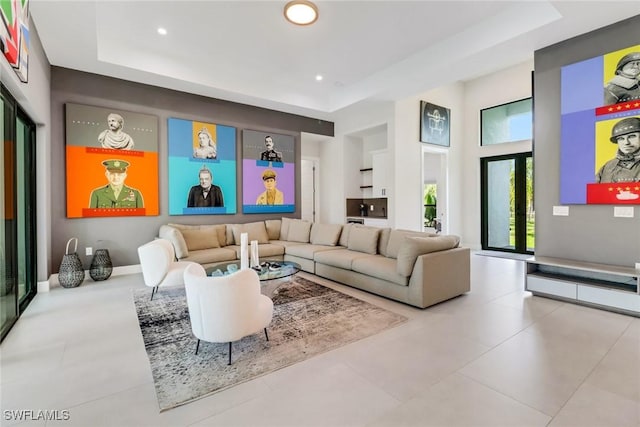 living room with a raised ceiling and a towering ceiling