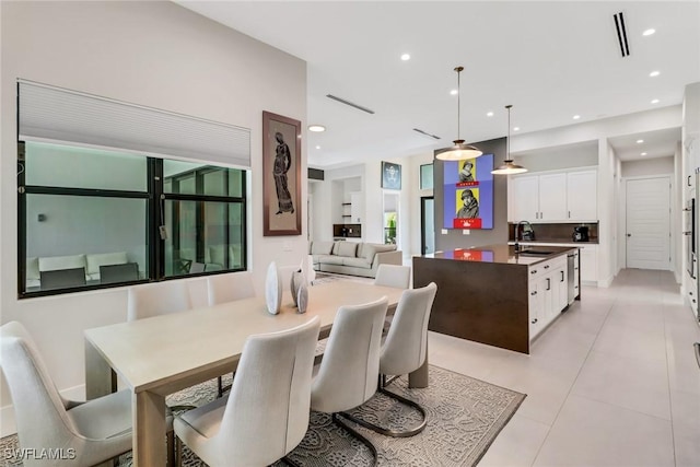 dining space with sink and light tile patterned flooring