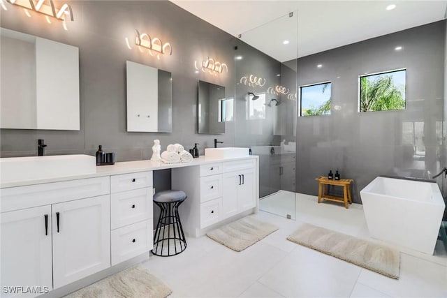 bathroom featuring tile patterned floors, separate shower and tub, tile walls, and vanity