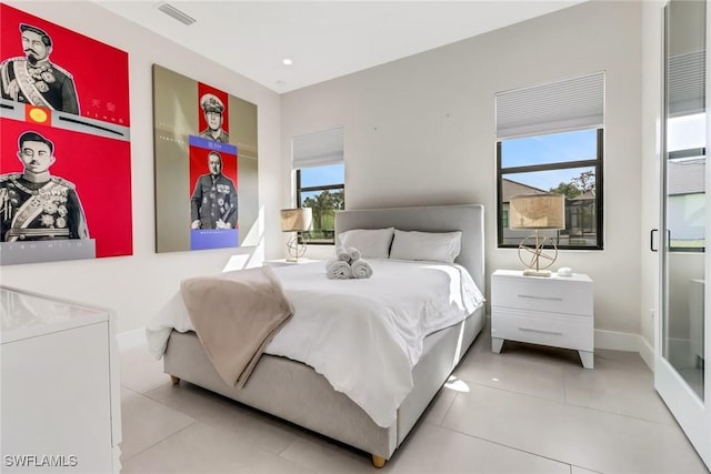 bedroom with multiple windows and tile patterned floors