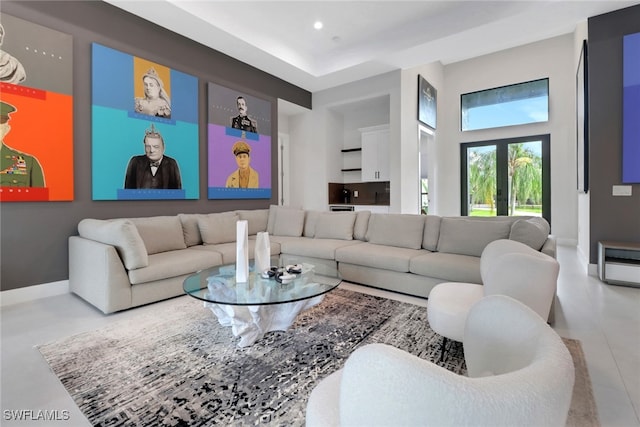 living room featuring french doors and a towering ceiling