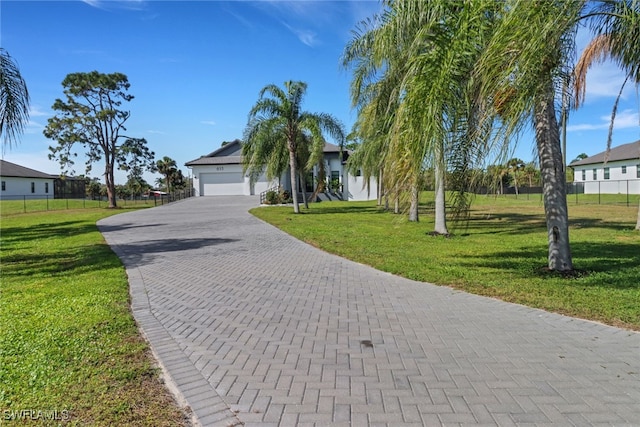 view of front facade featuring a garage and a front lawn