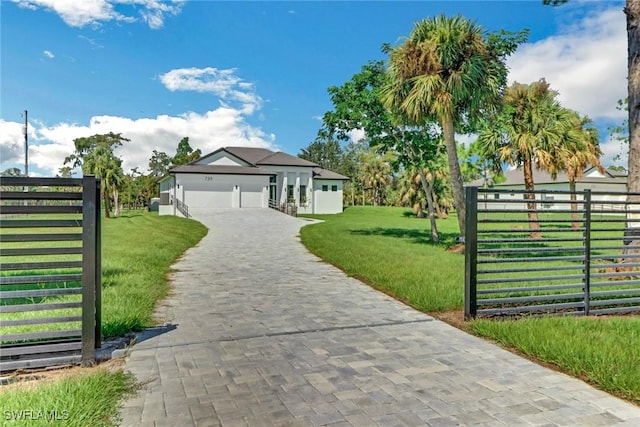 view of front of home featuring a garage and a front yard