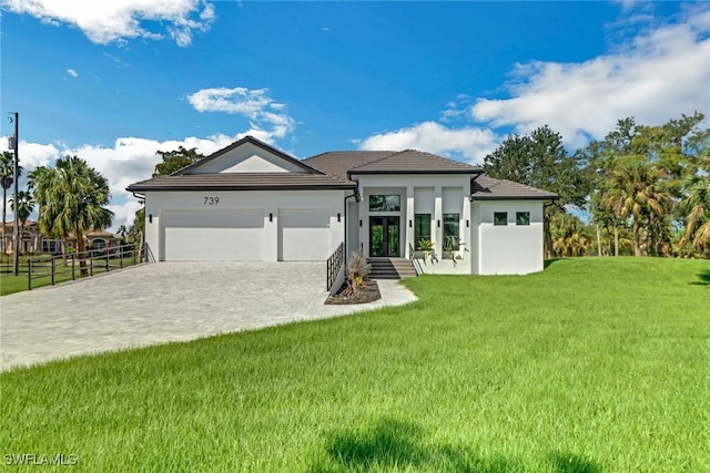 view of front of house featuring a garage and a front lawn