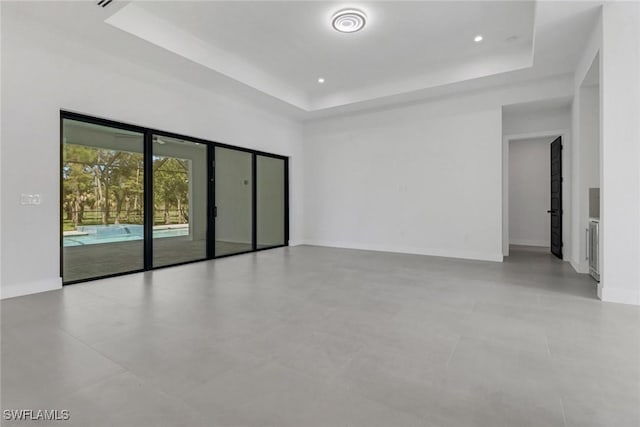 spare room featuring a raised ceiling