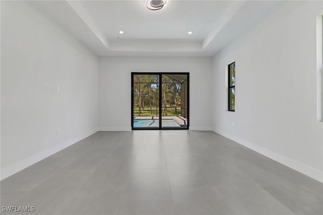 unfurnished room with a tray ceiling