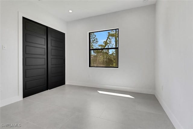 unfurnished bedroom with light tile patterned flooring