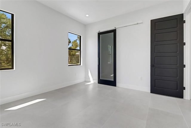 tiled empty room with a barn door