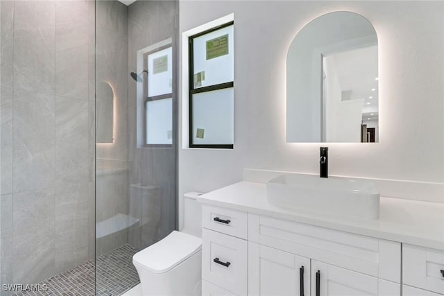 bathroom with vanity, an enclosed shower, and toilet