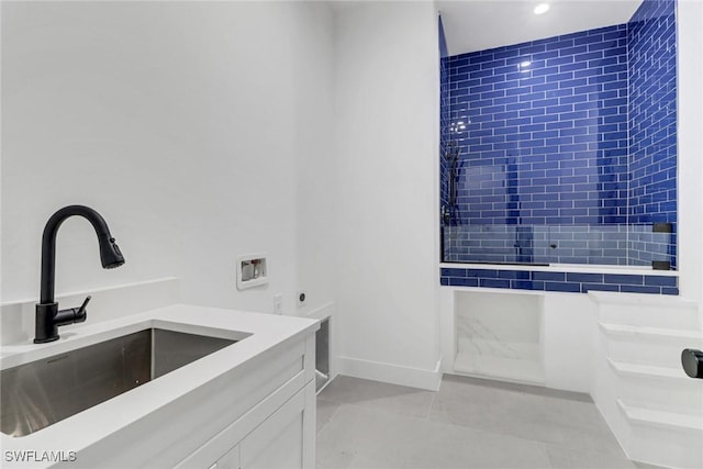 bathroom featuring vanity, tile patterned flooring, and tiled shower