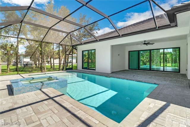 view of swimming pool with a patio, ceiling fan, an in ground hot tub, and a lanai