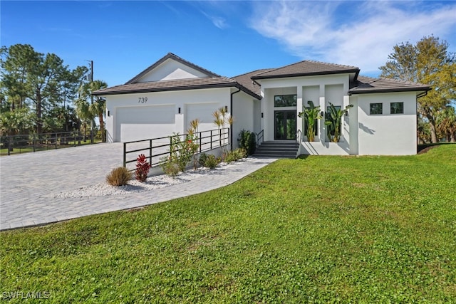 view of front facade with a garage and a front lawn