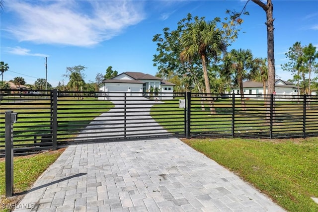 view of gate featuring a lawn