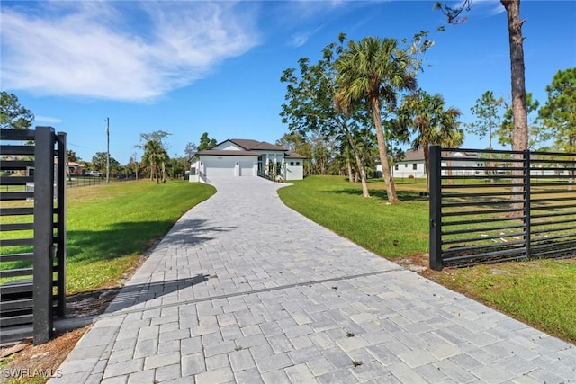 view of front of property featuring a front lawn and a garage