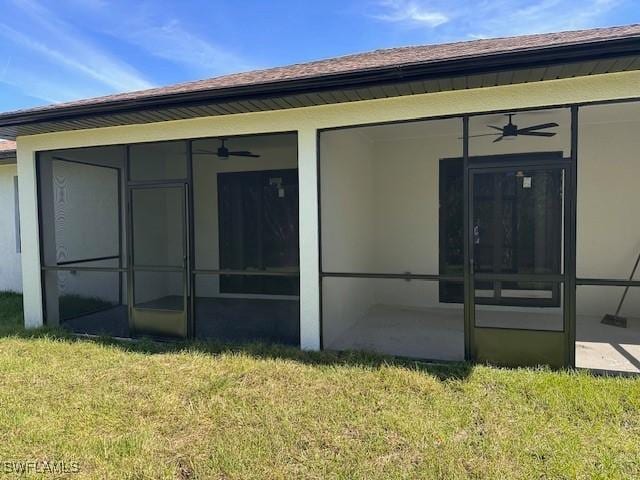 view of home's exterior featuring a sunroom and a lawn