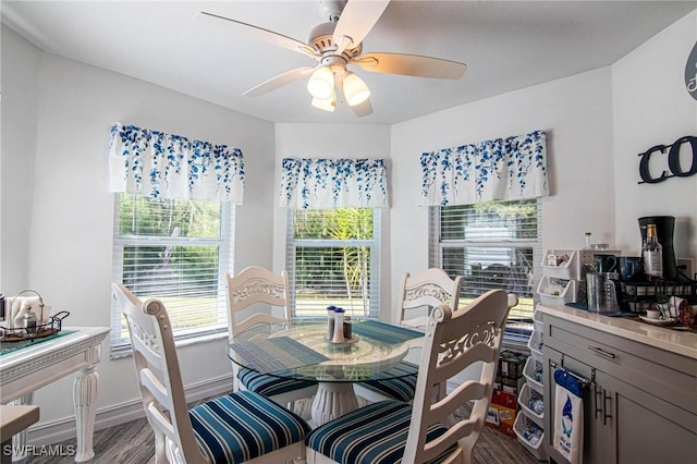 dining space with ceiling fan, wood finished floors, and baseboards