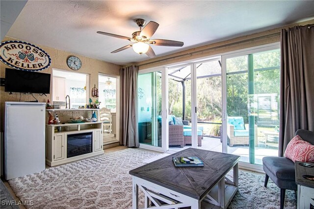 living room with a wealth of natural light and ceiling fan