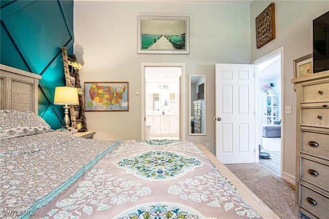 carpeted bedroom with ensuite bathroom