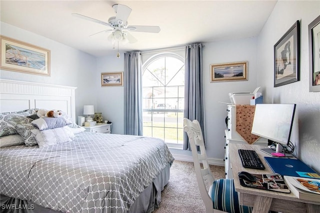 bedroom featuring multiple windows, light colored carpet, and ceiling fan