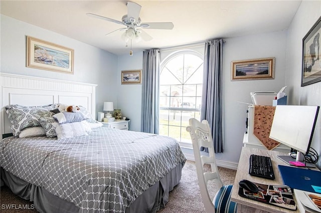 carpeted bedroom featuring ceiling fan and baseboards