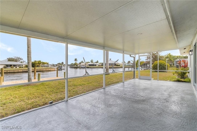 unfurnished sunroom with a water view