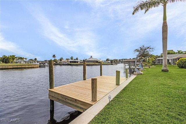 view of dock with a water view and a yard