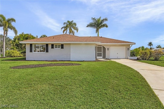 ranch-style house featuring a garage and a front lawn