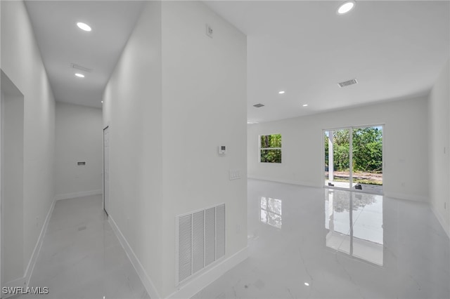hall with recessed lighting and baseboards