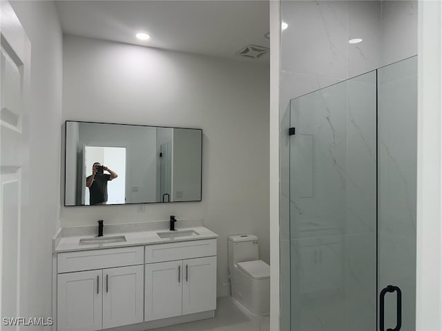 full bath with a marble finish shower, toilet, double vanity, and recessed lighting