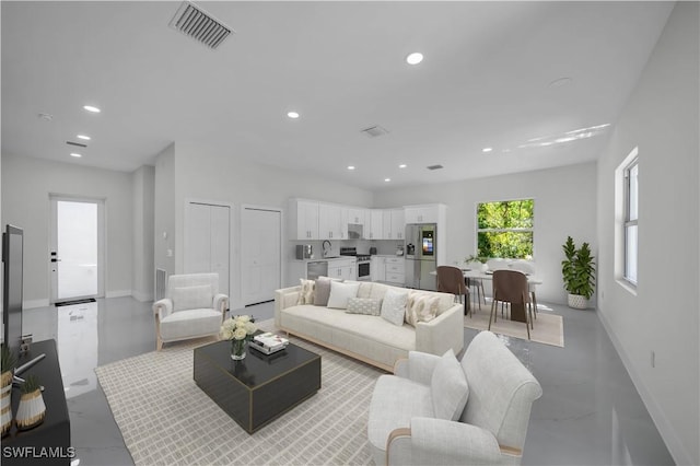 living area with recessed lighting and baseboards