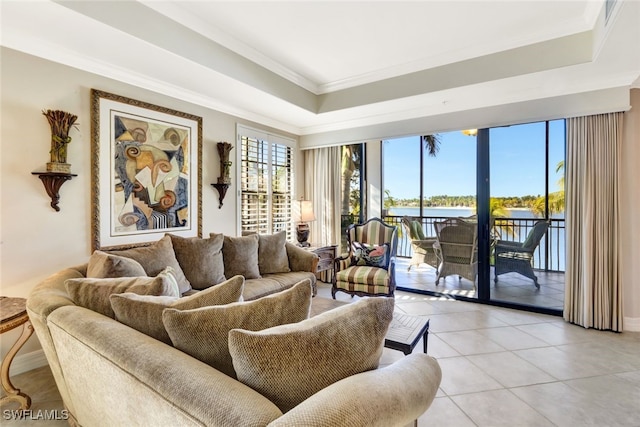 living room with light tile patterned floors, a wealth of natural light, ornamental molding, and a water view