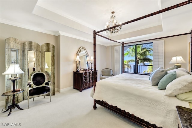 carpeted bedroom with a raised ceiling, crown molding, access to exterior, and an inviting chandelier