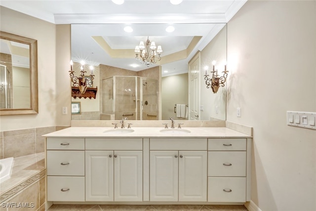 bathroom featuring crown molding, vanity, a notable chandelier, plus walk in shower, and a raised ceiling