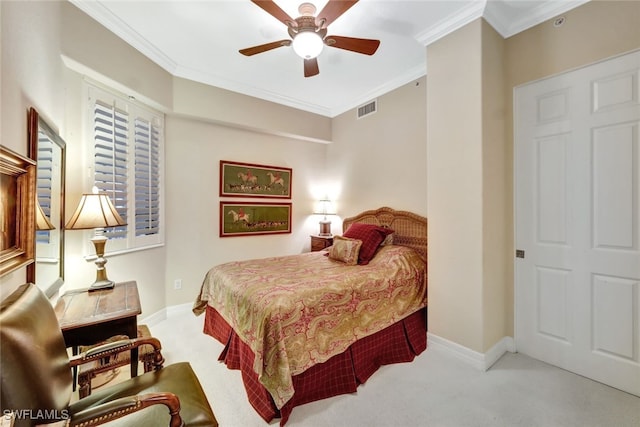 bedroom featuring crown molding, light colored carpet, and ceiling fan