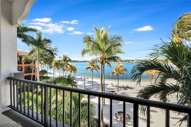 balcony featuring a water view and a beach view