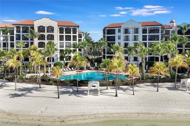 view of swimming pool with a patio and a water view