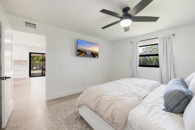 bedroom with multiple windows, ceiling fan, and light hardwood / wood-style flooring