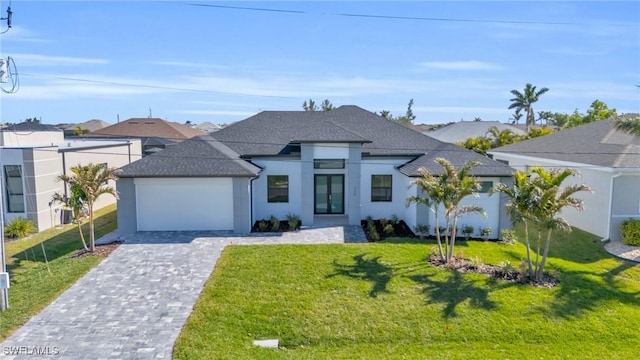 view of front of house featuring a garage and a front lawn