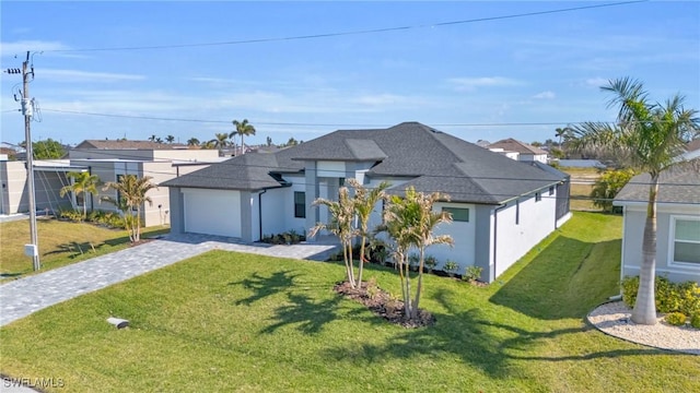 view of front of house featuring a garage and a front yard