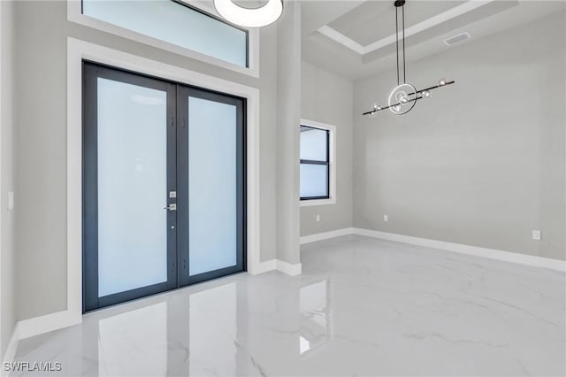 entryway with a towering ceiling and french doors